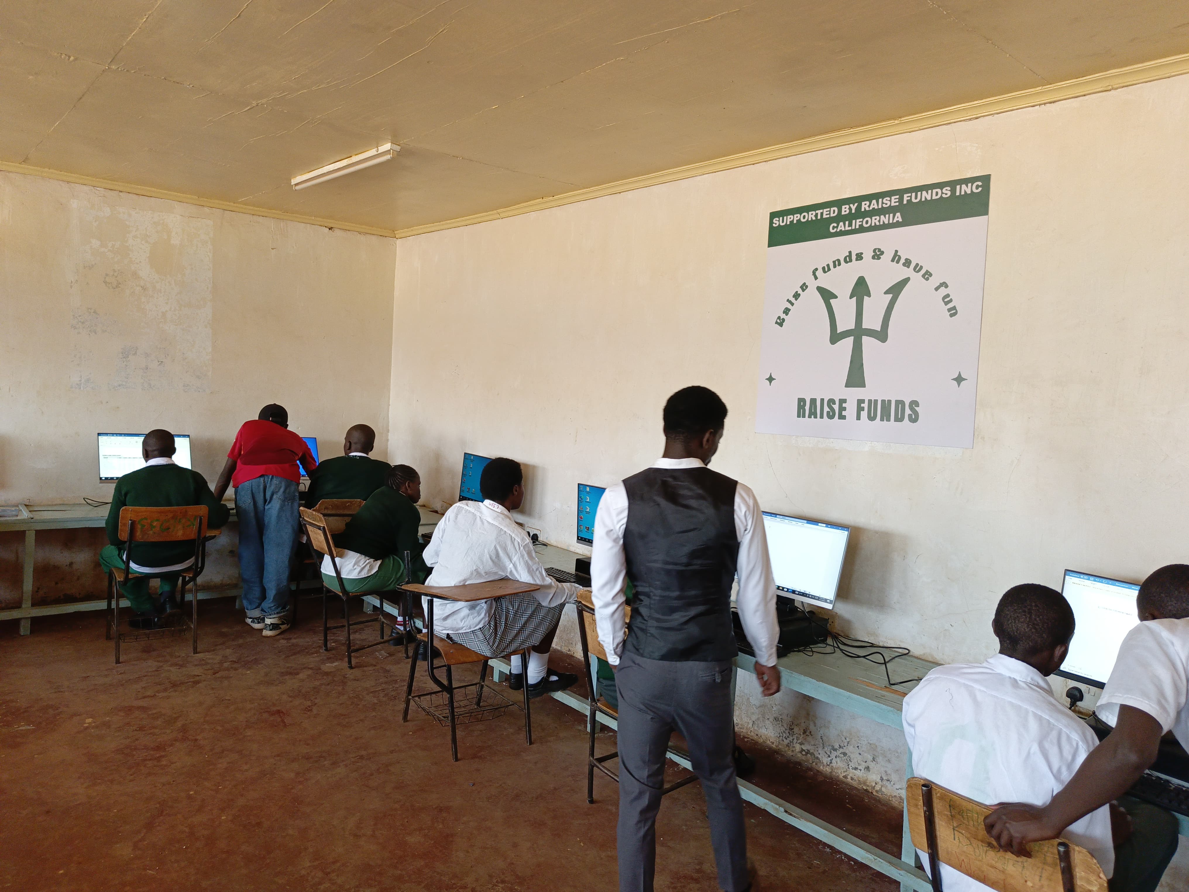 Kenyan children in classroom setting with digital devices, engaged in learning